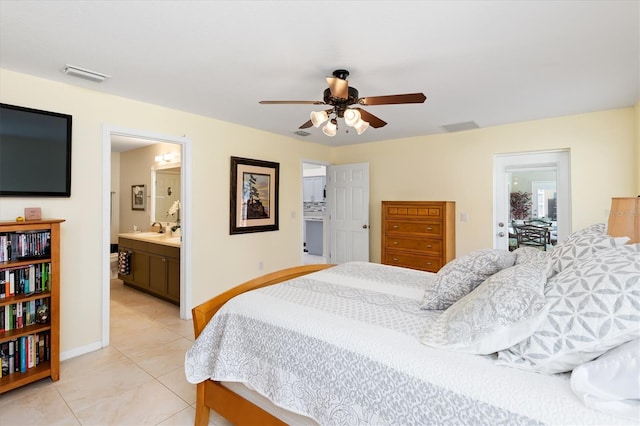 bedroom featuring light tile patterned floors, baseboards, visible vents, and a sink