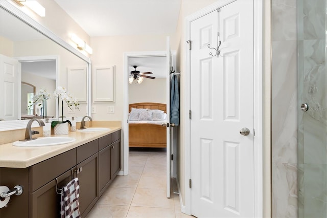 bathroom featuring double vanity, a ceiling fan, a sink, and tile patterned floors