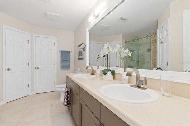 bathroom featuring a stall shower, visible vents, a sink, and tile patterned floors