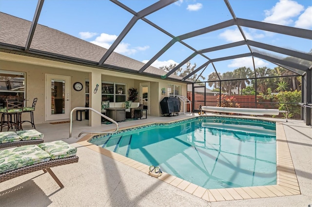 view of pool featuring a fenced in pool, a patio, glass enclosure, a grill, and fence