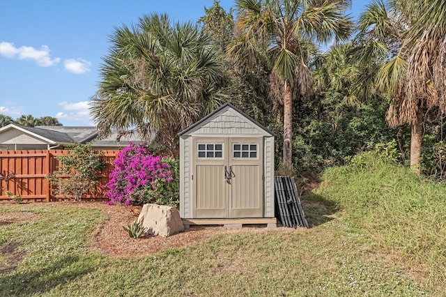 view of shed featuring fence