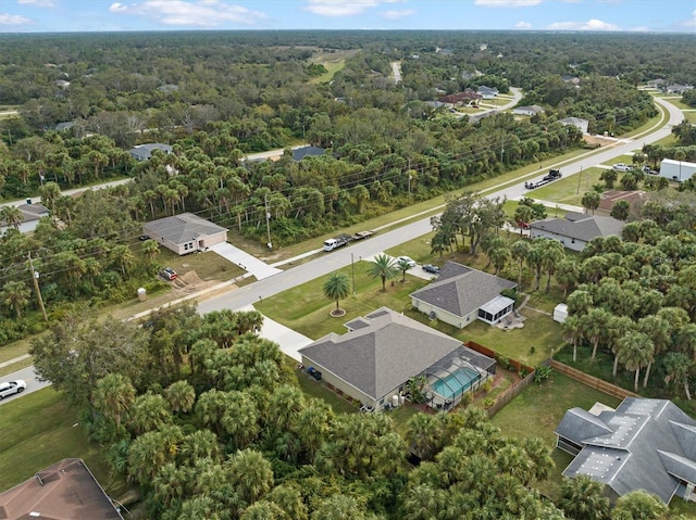 birds eye view of property featuring a forest view