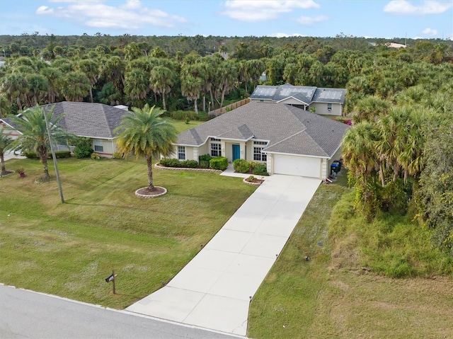 bird's eye view with a wooded view