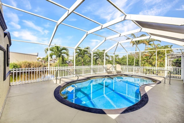 view of pool featuring a patio area, fence, a fenced in pool, and a lanai