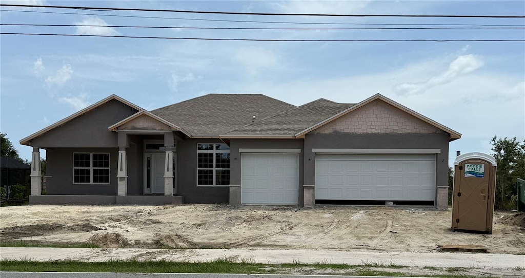 14735 Keystone Blvd, Port Charlotte, FL 33981 - view of front of home featuring an attached garage, stucco siding, and a shingled roof