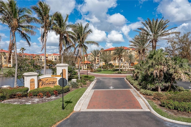 view of road with curbs, traffic signs, and a residential view