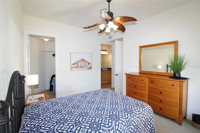 carpeted bedroom with ceiling fan, a spacious closet, visible vents, and a closet