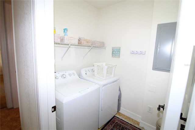 laundry room with laundry area, electric panel, baseboards, and separate washer and dryer