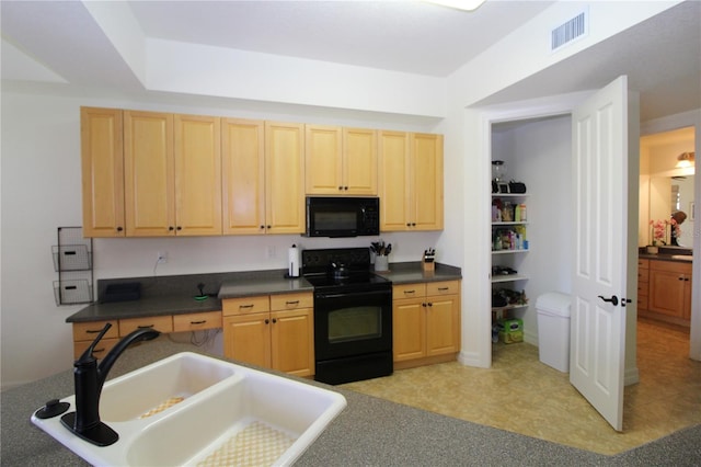 kitchen with dark countertops, visible vents, light brown cabinetry, a sink, and black appliances