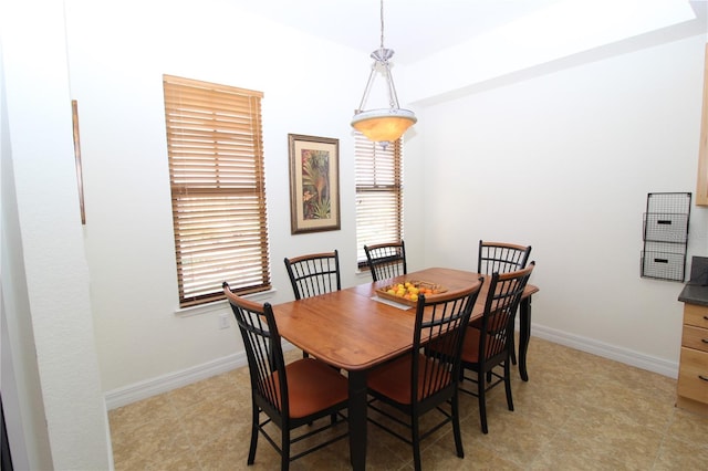 dining area featuring baseboards