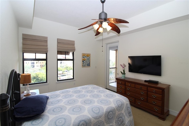 bedroom featuring access to outside, light colored carpet, and ceiling fan