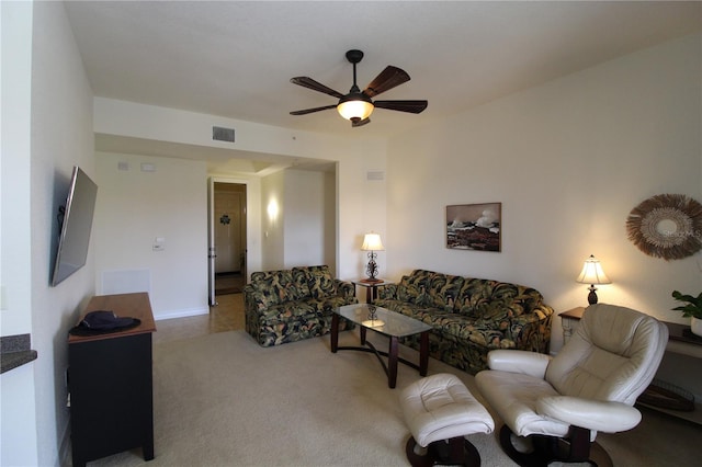 living room with carpet, visible vents, and a ceiling fan