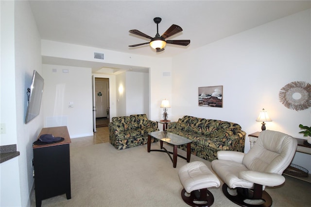 living room with light carpet, ceiling fan, and visible vents