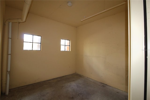 unfurnished room featuring unfinished concrete floors