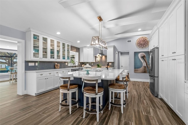 kitchen with light countertops, backsplash, and freestanding refrigerator