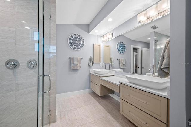 bathroom with baseboards, a shower stall, visible vents, and a sink