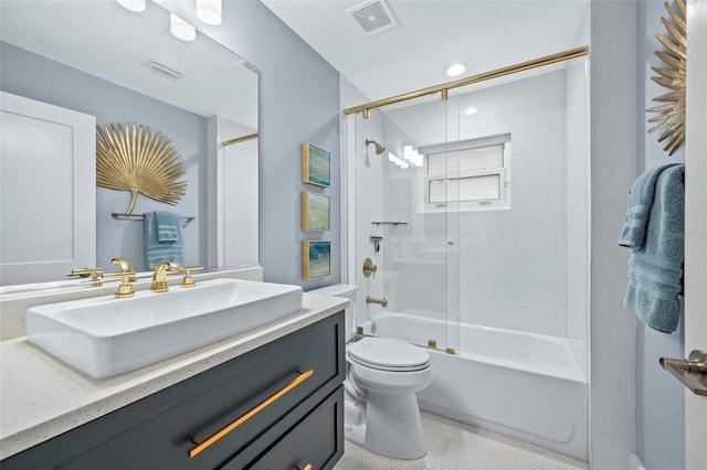 bathroom with visible vents, vanity, toilet, and combined bath / shower with glass door