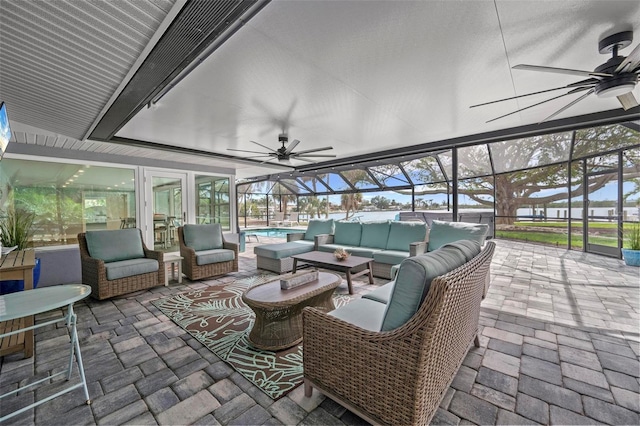 view of patio / terrace featuring an outdoor hangout area, glass enclosure, ceiling fan, and an outdoor pool