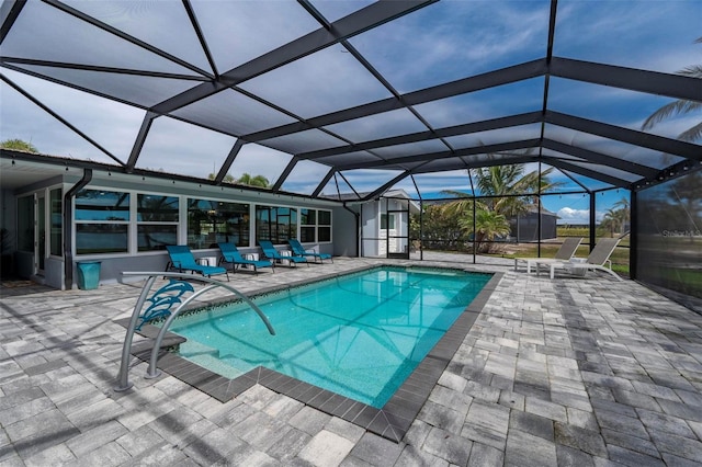 pool featuring a patio and glass enclosure