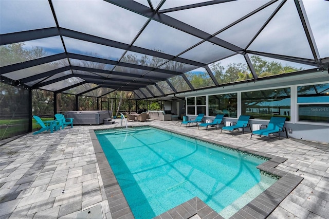 outdoor pool with a lanai, a hot tub, outdoor lounge area, and a patio