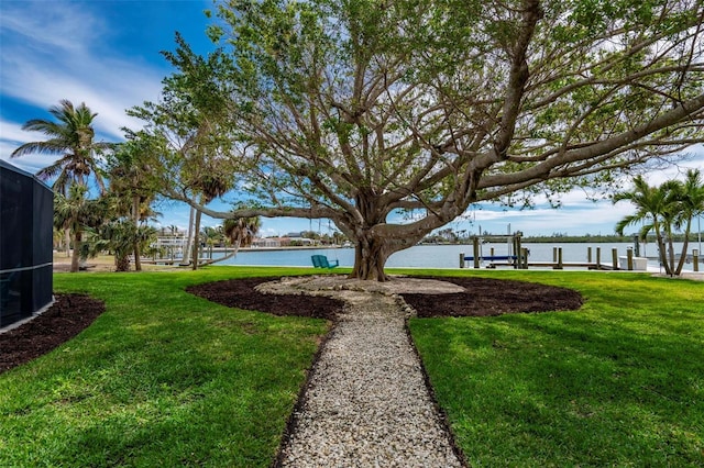 view of yard featuring a boat dock and a water view