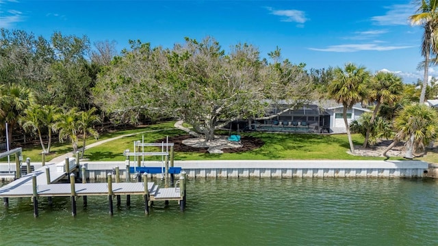 view of dock with a yard, a water view, and boat lift