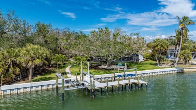 view of dock with a yard, a water view, and boat lift