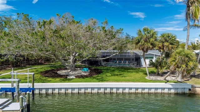 view of dock with boat lift, a lawn, a water view, and a lanai