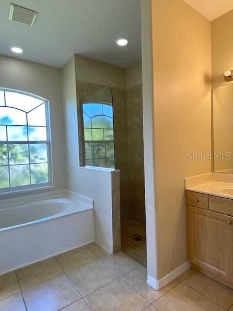 bathroom with vanity, tile patterned floors, a walk in shower, and visible vents