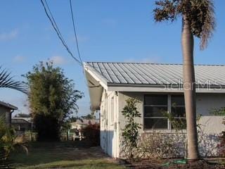 view of side of property with metal roof