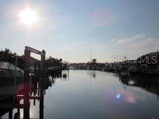 property view of water featuring a boat dock