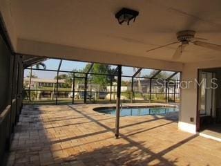 pool featuring a ceiling fan, a lanai, and a patio area