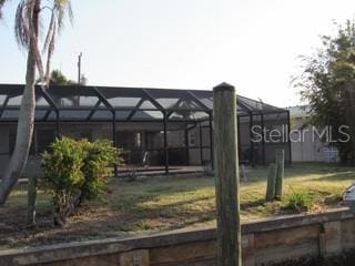 view of yard featuring glass enclosure