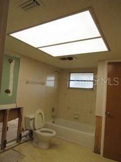 bathroom with toilet, visible vents, and shower / bathtub combination