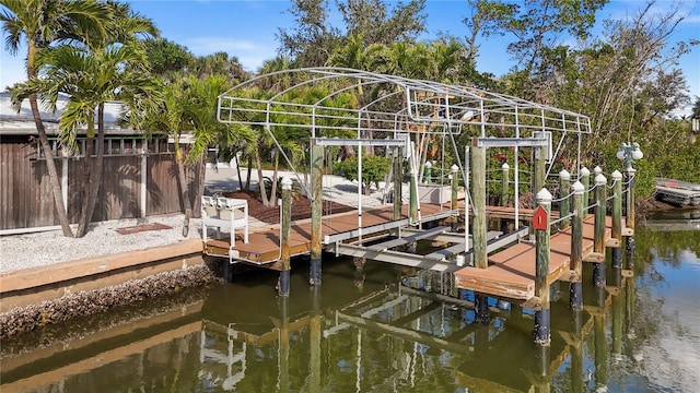 dock area with a water view and boat lift