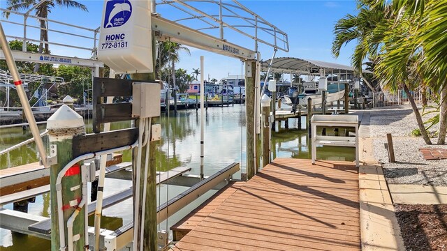 view of dock featuring a water view and boat lift