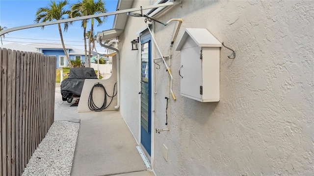 exterior space featuring fence and stucco siding