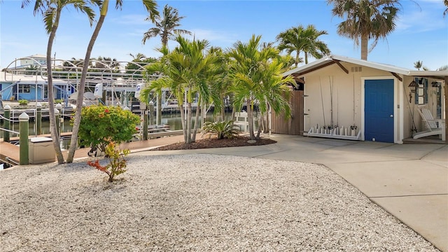 view of property's community featuring a dock and a water view