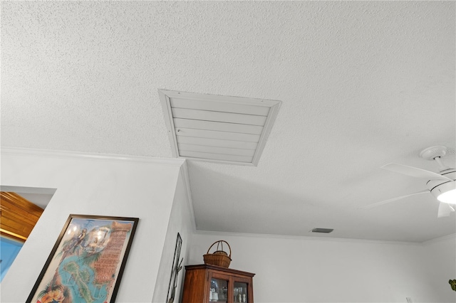 interior details with crown molding and a ceiling fan