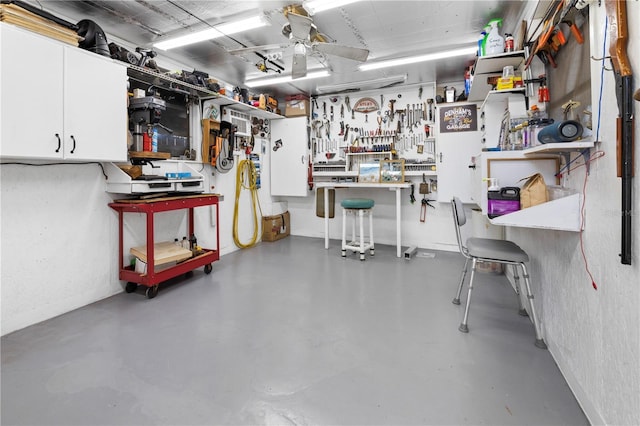 garage featuring ceiling fan and a workshop area