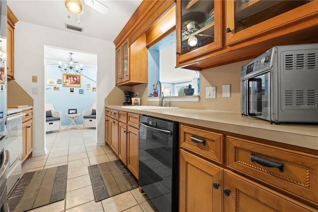 kitchen featuring black dishwasher, a toaster, a sink, and brown cabinets