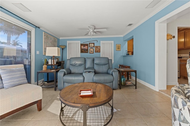 living area with ceiling fan, crown molding, baseboards, and light tile patterned floors