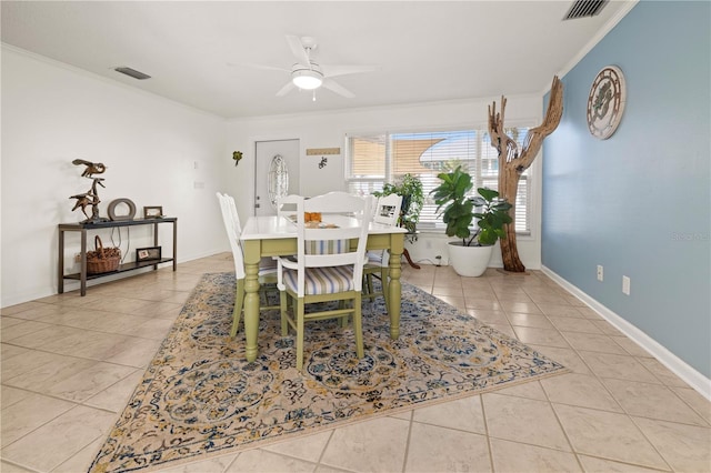 tiled dining area featuring a ceiling fan, baseboards, visible vents, and crown molding