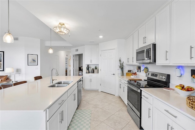 kitchen featuring stainless steel appliances, a sink, light countertops, and white cabinetry