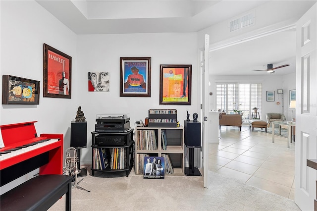 interior space featuring ceiling fan, carpet floors, visible vents, and tile patterned floors