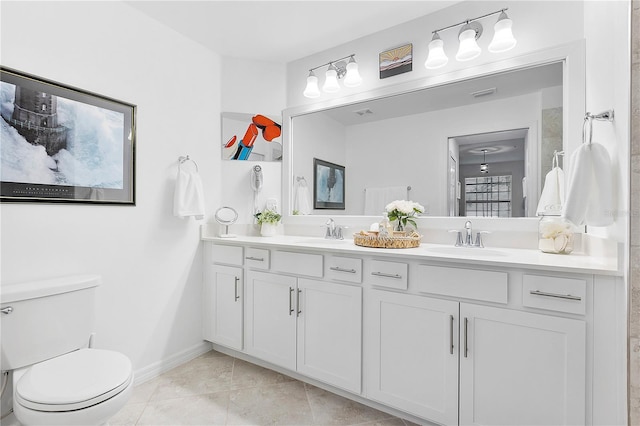 full bath with double vanity, a sink, toilet, and baseboards