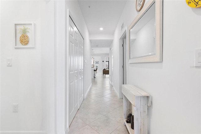 corridor with recessed lighting, visible vents, baseboards, and light tile patterned flooring