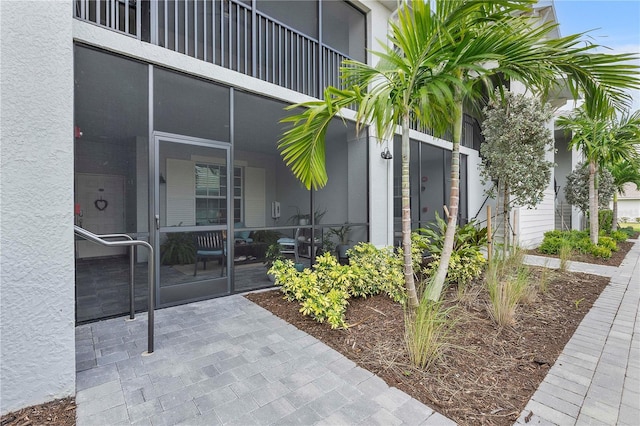 view of exterior entry featuring stucco siding