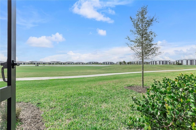 view of home's community with a yard