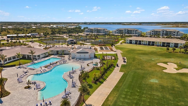 aerial view with golf course view and a water view